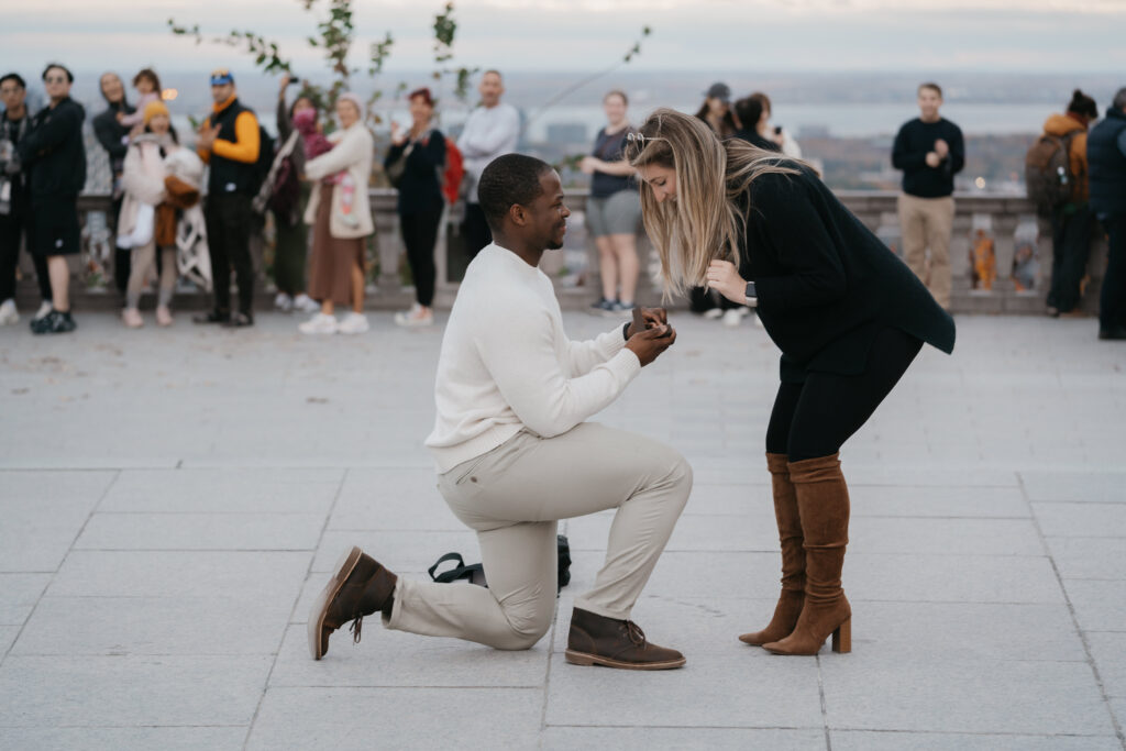 a man is doing a surprise proposal to his girlfriend at the mont royal