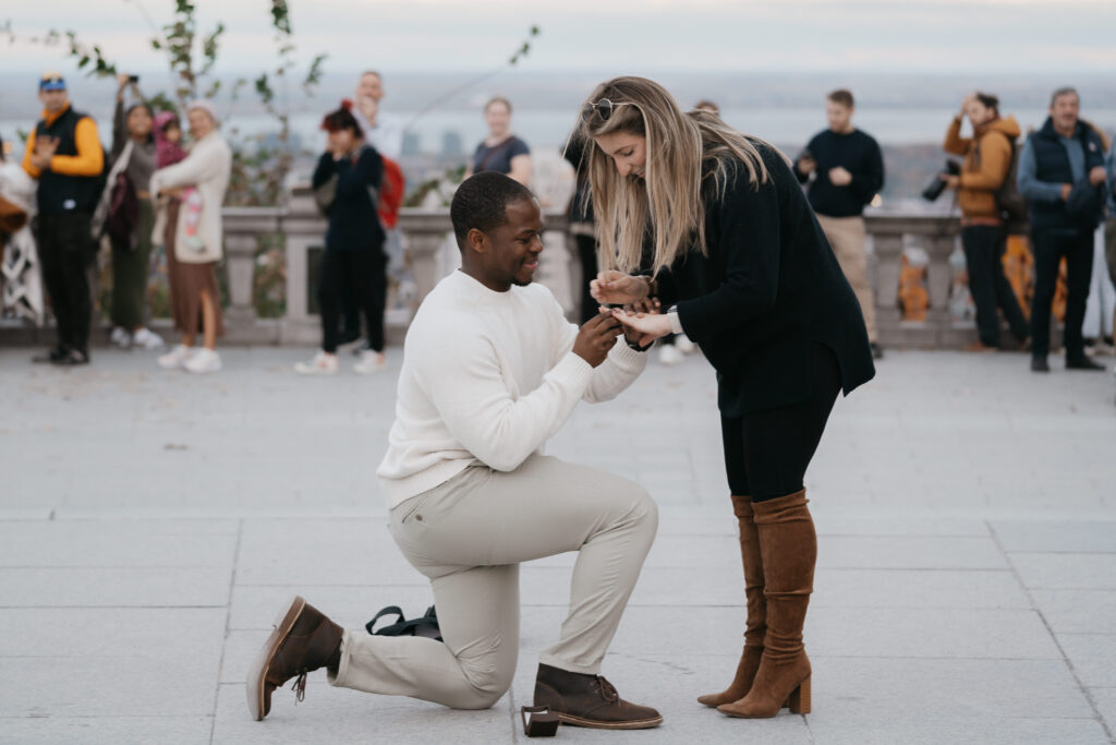 a man is doing a surprise proposal to his girlfriend at the mont royal