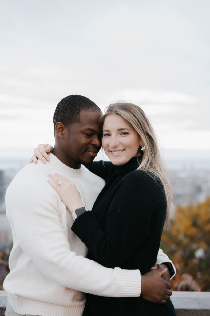 Happy couple posing for engagement photos in Montreal after a surprise proposal.