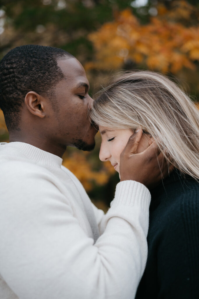 Couple embracing after a successful surprise proposal in Montreal's Mont Royal