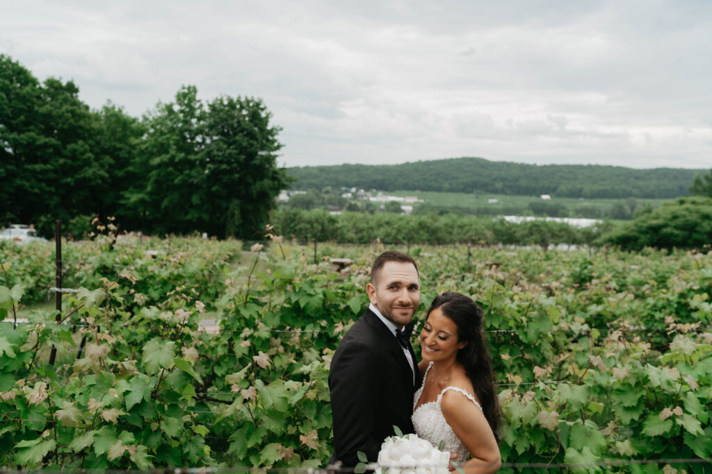 couple getting their photo done in the vineyard at la bullerie