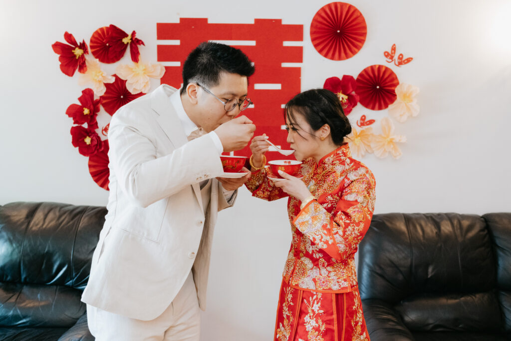 newly married chinese couple eating a sweet soup