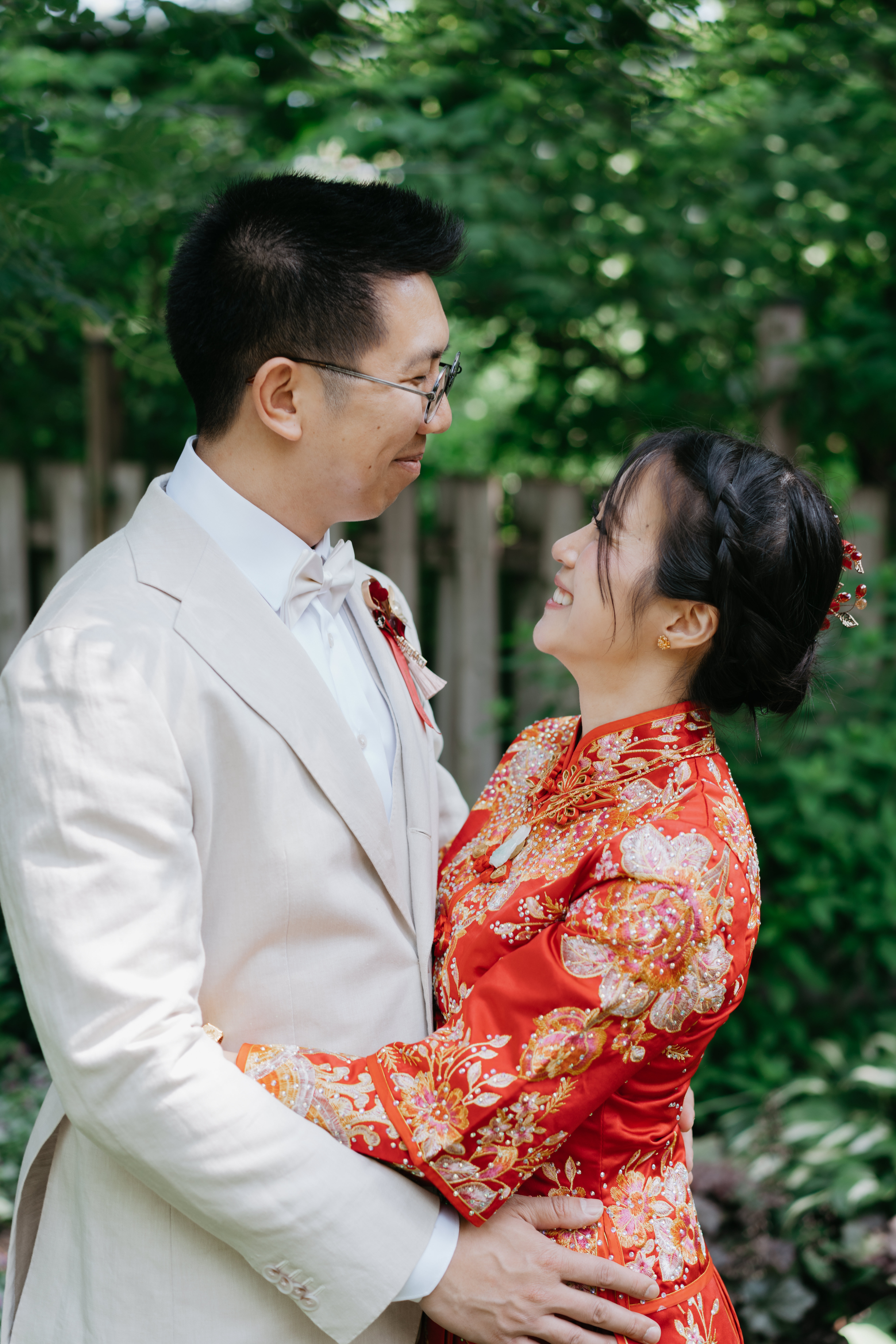 chinese couple facing each other. and holding on to each other.