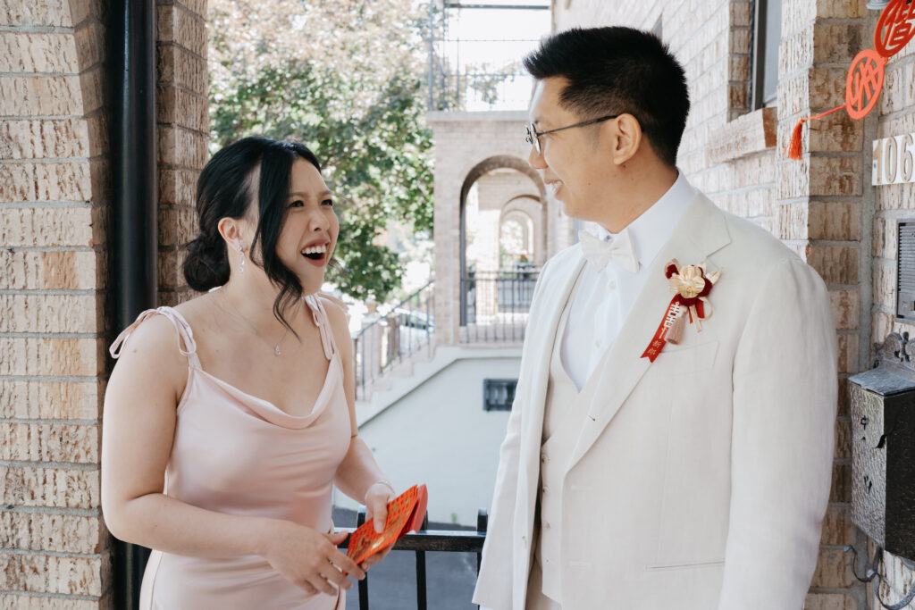The groom and his sister preparing red envelopes for the door games at a chinese wedding in Montreal