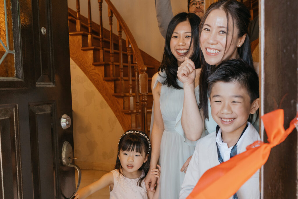 Family negotiating with the groom red envelopes during the door games at a chinese wedding in Montreal